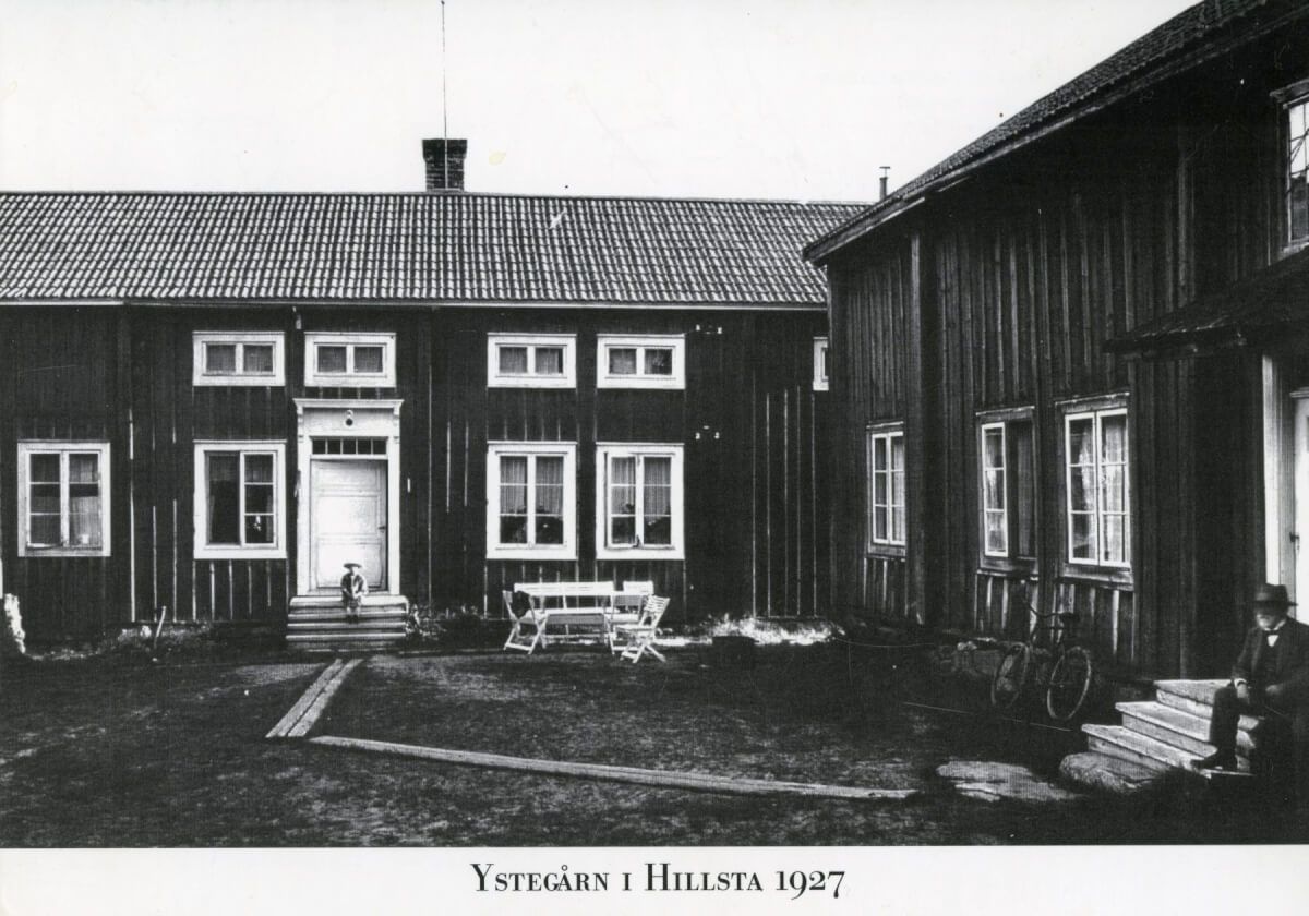 En pojke och en man sitter på varsin trappa vid Ystegården.